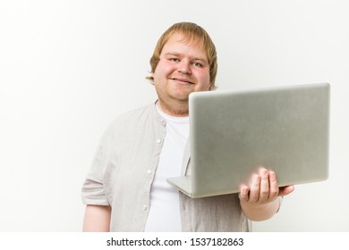 Caucasian Plus Size Man Holding A Laptop Happy, Smiling And Cheerful.