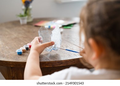 Caucasian Preschool Girl Doing Crafts With Plastic Bottle And Paints. Recycle Upcycling Waste. Sustainable Lifestyle