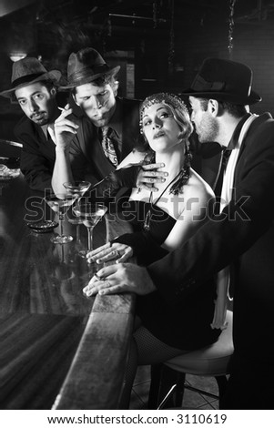 Caucasian prime adult retro female sitting at bar surrounded by suitors.