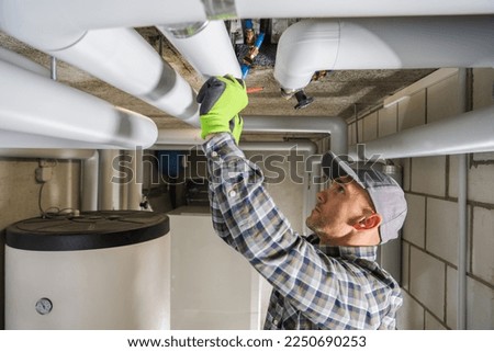 Caucasian Professional Plumbing Contractor in His 40s Finishing Sanitary Pipeline Installation.