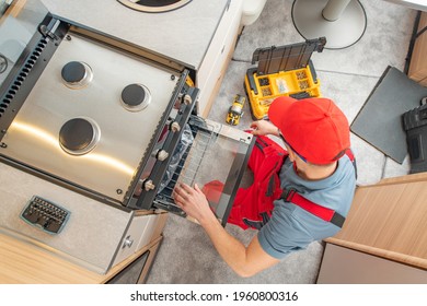 Caucasian RV Technician In His 40s Replacing Broken Travel Trailer Gas Stove. Camper Appliances.