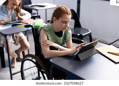 Caucasian schoolgirl in wheelchair with diverse schoolchildren in school classroom. Education, inclusivity, school, learning and disability concept. - Powered by Shutterstock