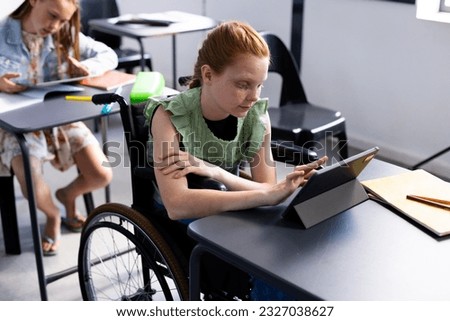 Caucasian schoolgirl in wheelchair with diverse schoolchildren in school classroom. Education, inclusivity, school, learning and disability concept.