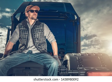 Caucasian Semi Truck Driver Seating On A Tractor And Waiting For Trailer.