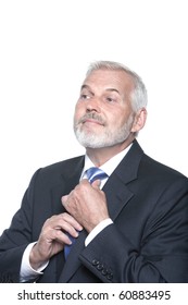 caucasian senior businessman portrait adjusting necktie isolated studio on white background
