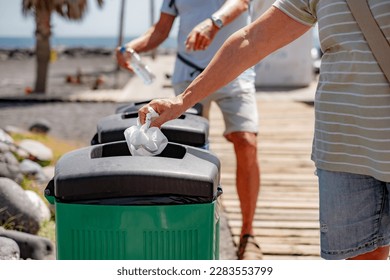 Caucasian Senior Couple of People Throwing Away Waste in Recycle Containers, Differentiated Collection Concept - Powered by Shutterstock