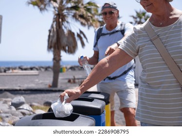 Caucasian Senior Couple of People Throwing Away Waste in Recycle Containers, Differentiated Collection Concept - Powered by Shutterstock