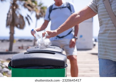 Caucasian Senior Couple of People Throwing Away Waste in Recycle Containers, Differentiated Collection Concept - Powered by Shutterstock