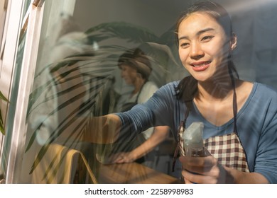 Caucasian senior elderly woman cleaning kitchen in house with daughter. Attractive female housekeeper and mature cleaner wear apron, feel happy and relax while working for housework or chores at home. - Powered by Shutterstock