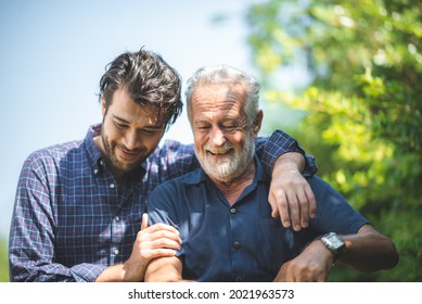 caucasian senior father and adult son are hugging together at home, generation family are happy with people love, male mature, old person man, elderly grandfather smiling living at the house - Powered by Shutterstock