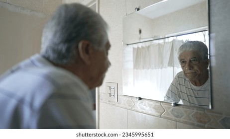Caucasian Senior Man Reflecting on Regret and Sorrow, Contemplating Old Age in Bathroom Mirror - Powered by Shutterstock