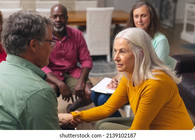 Caucasian Senior Man And Woman Talking During Group Therapy Session. Unaltered, Support, Alternative Therapy, Community Outreach, Mental Wellbeing And Social Gathering.