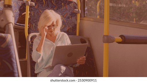 Caucasian senior woman wearing her glasses and using laptop in the bus. Technology and people concept - Powered by Shutterstock