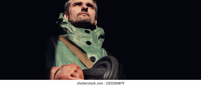 Caucasian Serious Rescuer Portrait Isolated Over Black Background. Face Of Man In Protective Coverall.