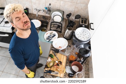 Caucasian Single Man Exhausted Because Of The Chaos Of His Kitchen. Top View, Wide Angle