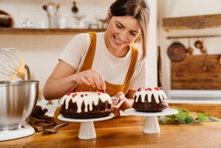 Caucasian Smiling Pastry Chef Woman Making Chocolate Cake At Cozy Kitchen
