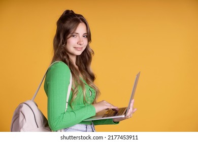 Caucasian Smiling Teenager Holding Laptop And Backpack 