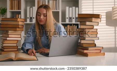 Caucasian student happy smiling girl woman studying with laptop and books homework learning online knowledge prepare for test exam study at library cram SAT test bookworm research history prep course