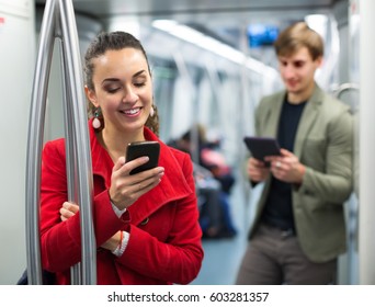 Caucasian Subway Passengers Busy With Modern Phones And Tablet