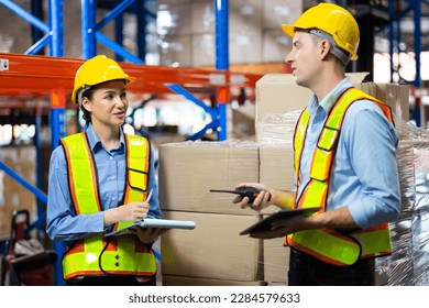 Caucasian team man and woman worker working at warehouse factory. Warehouse staff worker standing by goods shelf working in large warehouse - Powered by Shutterstock