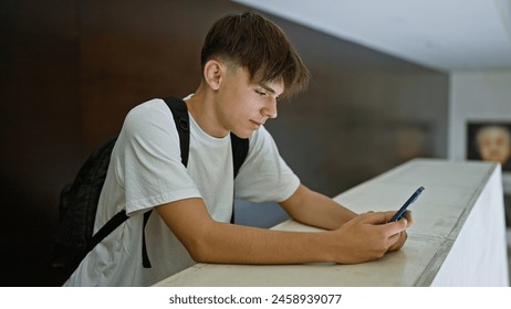 Caucasian teen boy texting on smartphone at school - Powered by Shutterstock