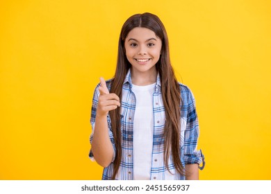 caucasian teen girl in casual style. trendy teen caucasian girl point finger. young caucasian teen girl look at the camera isolated on yellow. teen caucasian girl wear checkered shirt in studio - Powered by Shutterstock