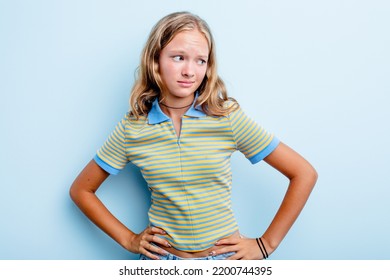 Caucasian Teen Girl Isolated On Blue Background Confused, Feels Doubtful And Unsure.