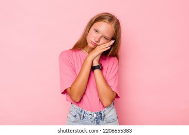 Caucasian Teen Girl Isolated On Pink Background Yawning Showing A Tired Gesture Covering Mouth With Hand.