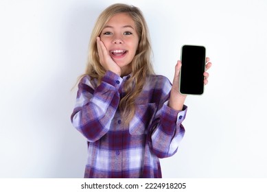 Caucasian Teen Girl Wearing Plaid Purple Shirt Over White Wall Hold Hand Modern Technology Use Touch Face Palm Astonished Impressed Scream Wow Omg Unbelievable Unexpected