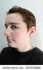 A Caucasian Teenage Male With Red Hair And Freckles Looks At The Camera With A Pensive Expression. Portrait Photo Of A Youth Boy With Brown Eyes And Short, Ginger Hair. Selective Focus.