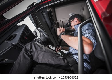 Caucasian Truck Driver Using Seat Belts For His Safety. Heavy Transportation Safety.