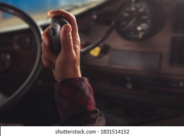 Caucasian Trucker Communicate With Other Truck Drivers In Convoy Via CB Radio Close Up Concept. Transportation Industry Theme.