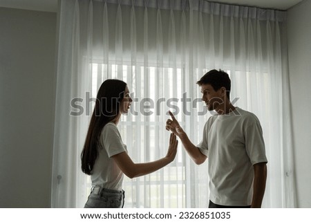 Caucasian unhappy couple having quarreling fight argument with painful. New marriage man and woman crying feel heartbroken for their quarrel conflict in living room. Family problem-separation concept.