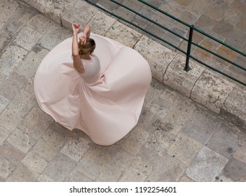 Caucasian white dancer, graceful woman stretching in the natural street background, ballet background, top view.The top view of the ballerina dancing in the street. Dancer in Valletta - Powered by Shutterstock
