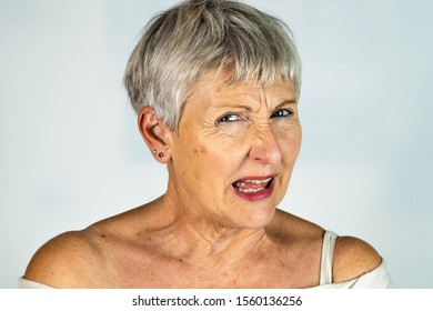 Caucasian White Haired Older Woman With Furious Look And Screaming In White Background