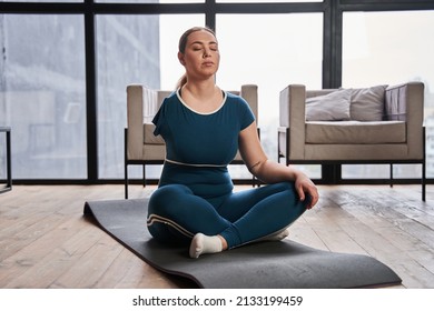 Caucasian Woman With Amputee Arm Meditating At Home In The Morning And Practicing Yoga