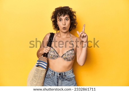 Caucasian woman in bikini with beach bag, studio having some great idea, concept of creativity.