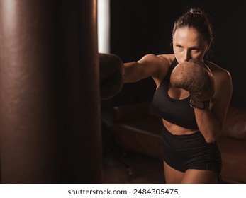 Caucasian woman boxing in retro gym.  - Powered by Shutterstock