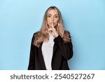 Caucasian woman in business jacket keeping a secret or asking for silence.