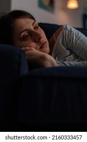 Caucasian Woman With Chronic Depression Feeling Sad In Living Room, Dealing With Mental Health Disease And Illness. Depressed Anxious Person In Despair Laying On Couch. Close Up.