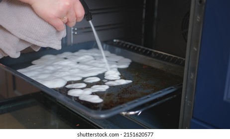 Caucasian Woman Cleaning Kitchen Oven Spraying Grease Remover Foam On Drip Pan