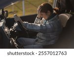 Caucasian woman cries while driving. 