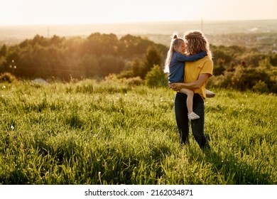 Caucasian woman with daughter at the meadow  - Powered by Shutterstock