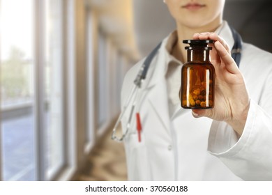 caucasian woman doctor and brown bottle 