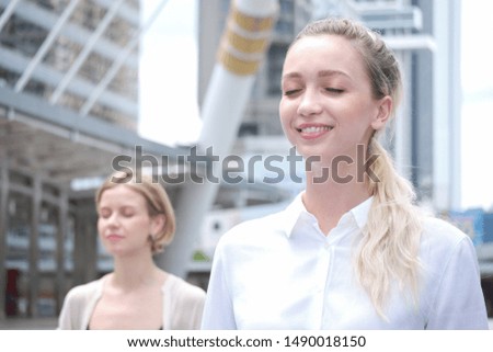 Similar – Young, tall woman sits in a summer dress on the beach of the Baltic Sea and smiles