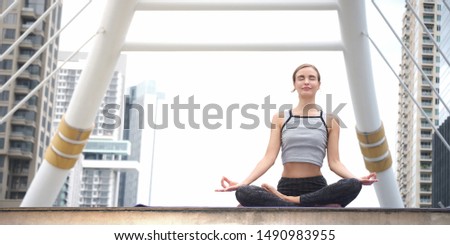 Similar – Young, tall woman sits in a summer dress on the beach of the Baltic Sea and smiles