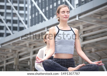 Similar – Young, tall woman sits in a summer dress on the beach of the Baltic Sea and smiles