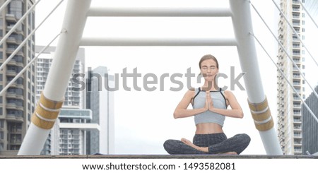 Similar – Young, tall woman sits in a summer dress on the beach of the Baltic Sea and smiles