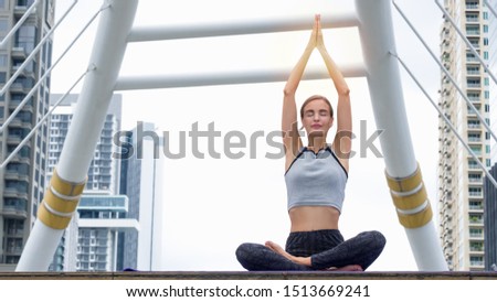 Similar – Young, tall woman sits in a summer dress on the beach of the Baltic Sea and smiles