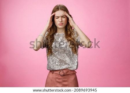 Caucasian woman feeling dizzy drink too much alcohol party, touching temples close eyes frowning suffering headache feeling discomfort, migraine, standing displeased unwell pink background